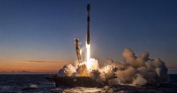 Falcon 9 booster landing on drone ship at dusk