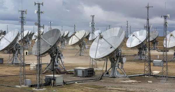 Satellite dish antenna farm pointed at sky with communications infrastructure