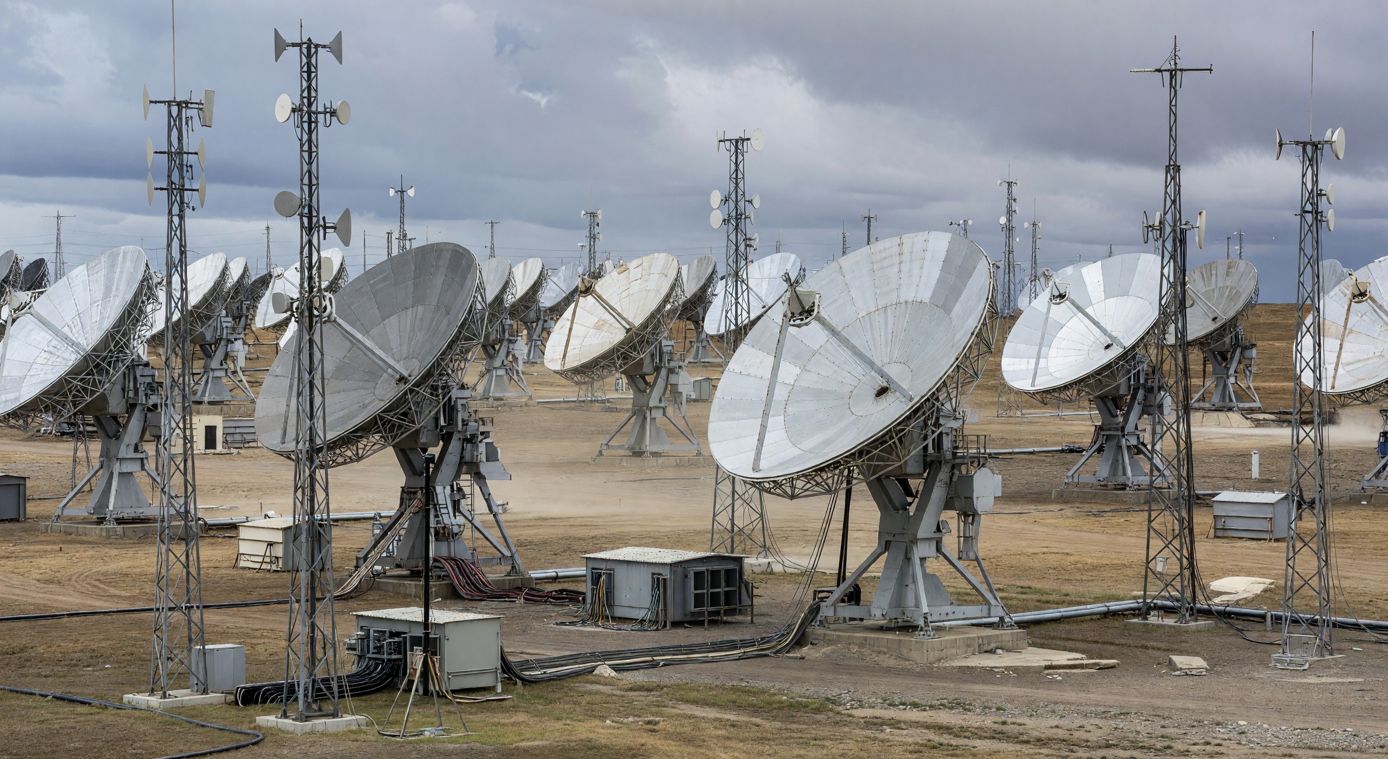Satellite dish antenna farm pointed at sky with communications infrastructure